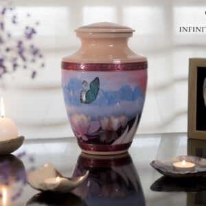 memorial table with a cremation urn of a butterfly with blue and Pink colors and a picture of my loved one