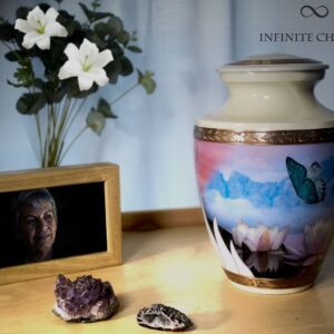 memorial table with a cremation urn of a butterfly with blue and yellow colors and a picture of my loved one